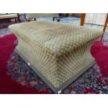 AN OTTOMAN UPHOLSTERED IN BROWN AND BEIGE DIAMOND DIAPER MATERIAL, THE SIDES WAISTED ABOVE A