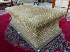 AN OTTOMAN UPHOLSTERED IN BROWN AND BEIGE DIAMOND DIAPER MATERIAL, THE SIDES WAISTED ABOVE A