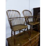 TWO SIMILAR ANTIQUE OAK AND ELM WINDSOR CHAIRS WITH SHALLOW SADDLE SEATS AND TURNED FRONT LEGS