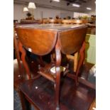 A EDWARDIAN DROP LEAF TWO TIER TABLE.