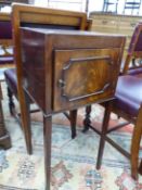 AN ANTIQUE MAHOGANY BEDSIDE CUPBOARD, THE CROSS BANDED TOP OVER A CUPBOARD AND TAPERING LEGS OF SQUA