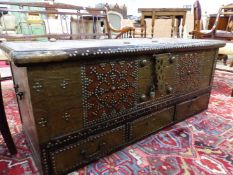 AN INDO PORTUGESE TEAK TRUNK WITH BRASS CLOSE NAILED DECORATION ABOUT THE PADLOCK PLATE AND ABOVE