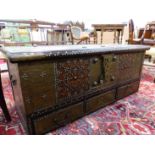 AN INDO PORTUGESE TEAK TRUNK WITH BRASS CLOSE NAILED DECORATION ABOUT THE PADLOCK PLATE AND ABOVE