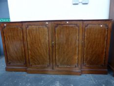 A 19th C. CROSS BANDED MAHOGANY BREAKFRONT BOOKCASE ON PLINTH FOOT. W 215 x D 46 x H 108cms.