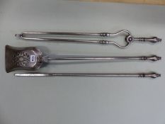 A SET OF THREE ANTIQUE POLISHED STEEL FIRE IRONS EACH WITH BALUSTER HANDLES