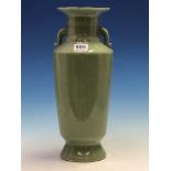 A CHINESE CRACKLED CELADON TWO HANDLED VASE, THE CYLINDRICAL BODY TAPERING FROM THE SHOULDERS TO THE