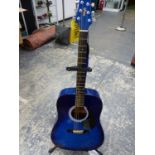 A STAGG BLUE ACOUSTIC GUITAR WITH A STAGG STAND