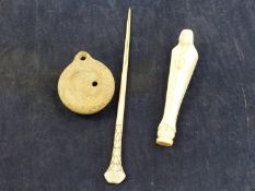 AN ANTIQUE AFRICAN IVORY PRAYING FIGURE, A IVORY HAIR STICK, AND A ROMAN OIL LAMP
