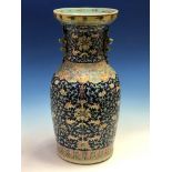 A CHINESE BLUE GROUND BALUSTER VASE WITH NOSE TO NOSE BUDDHIST LIONS FORMING HANDLES ON THE NECK