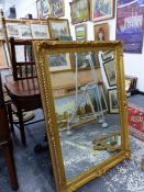 A LARGE GILT FRAMED MIRROR.