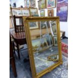 A LARGE GILT FRAMED MIRROR.