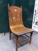 A CHILDS CHAIR, THE BACK AND SEAT OF A BENT SHEET OF PLYWOOD DRILLED WITH GEOMETRIC PATTERNS OF VARI