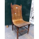 A CHILDS CHAIR, THE BACK AND SEAT OF A BENT SHEET OF PLYWOOD DRILLED WITH GEOMETRIC PATTERNS OF VARI