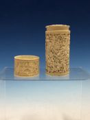 A CHINESE CARVED IVORY CYLINDRICAL BOX AND COVER DEPICTING VILLAGE SCENES IN LOW RELIEF. H 13cms.