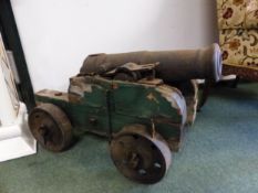 A PAIR OF ANTIQUE CANNONS ON WOODEN CARRIAGES, THE BARRELS. W 72cms. THE BARREL MOUTH. Dia. 5.5cms.