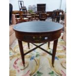 A GEORGIAN AND LATER MAHOGANY DRUM TOP LIBRARY TABLE ON SQUARE LEGS UNITED BY PIERCED STRETCHER.