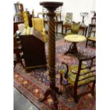 A MAHOGANY TRIPOD TORCHERE, THE DISHED CIRCULAR TOP ON A SPIRAL TURNED COLUMN, LEAVES CARVED AT