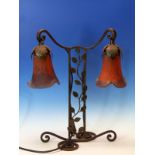 AN EDGAR BRANDT STYLE WROUGHT IRON TABLE LAMP SUPPORTING TO DAUM LIKE PURPLE FLECKED RED GLASS