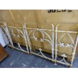 A PAIR OF WHITE PAINTED IRON GARDEN GATES, EACH WROUGHT WITH TREFOIL BARS SPROUTING IVY LEAVES. 90 x