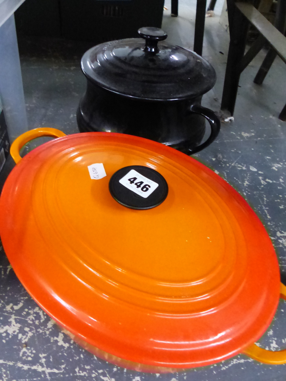 A LE CREUSET CASSEROLE DISH WITH LID, AND A POTTERY EXAMPLE.