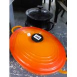 A LE CREUSET CASSEROLE DISH WITH LID, AND A POTTERY EXAMPLE.