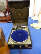 A VINTAGE PORTABLE GRAMOPHONE, A FRUIT PRESS AND A STOOL.