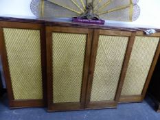 A 19th C. MAHOGANY BREAKFRONT SIDE CABINET, THE FOUR GRILLED DOORS LINED WITH YELLOW PLEATED SILK