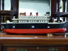 A SCALE MODEL PASSENGER SHIP MODEL, THREE CHIMNEYS ABOVE THE UPPER OF TWO DECKS, PORT HOLES IN THE