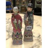 A PAIR OF CHINESE FAMILLE ROSE FIGURES OF A MANDARIN AND HIS WIFE RESPECTIVELY HOLDING A FLY WHISK