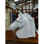 A LARGE PLASTER SCULPTURE OF A HORSE HEAD.