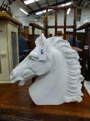 A LARGE PLASTER SCULPTURE OF A HORSE HEAD.
