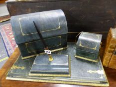 A GREEN LEATHER DESK SET WITH GILT DETAILS, COMPRISING: BLOTTER, STRING DISPENSER, SCISSORS,