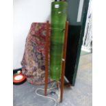 A 20th C. FLOOR STANDING "ROCKET" LAMP, THE CYLINDRICAL GREEN SHADE SUPPORTED BY THREE MAHOGANY
