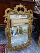 A GILT FRAMED MIRROR IN THE ROCOCO TASTE.