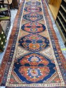 AN ANTIQUE PERSIAN TRIBAL RUNNER, 479 x 129cms