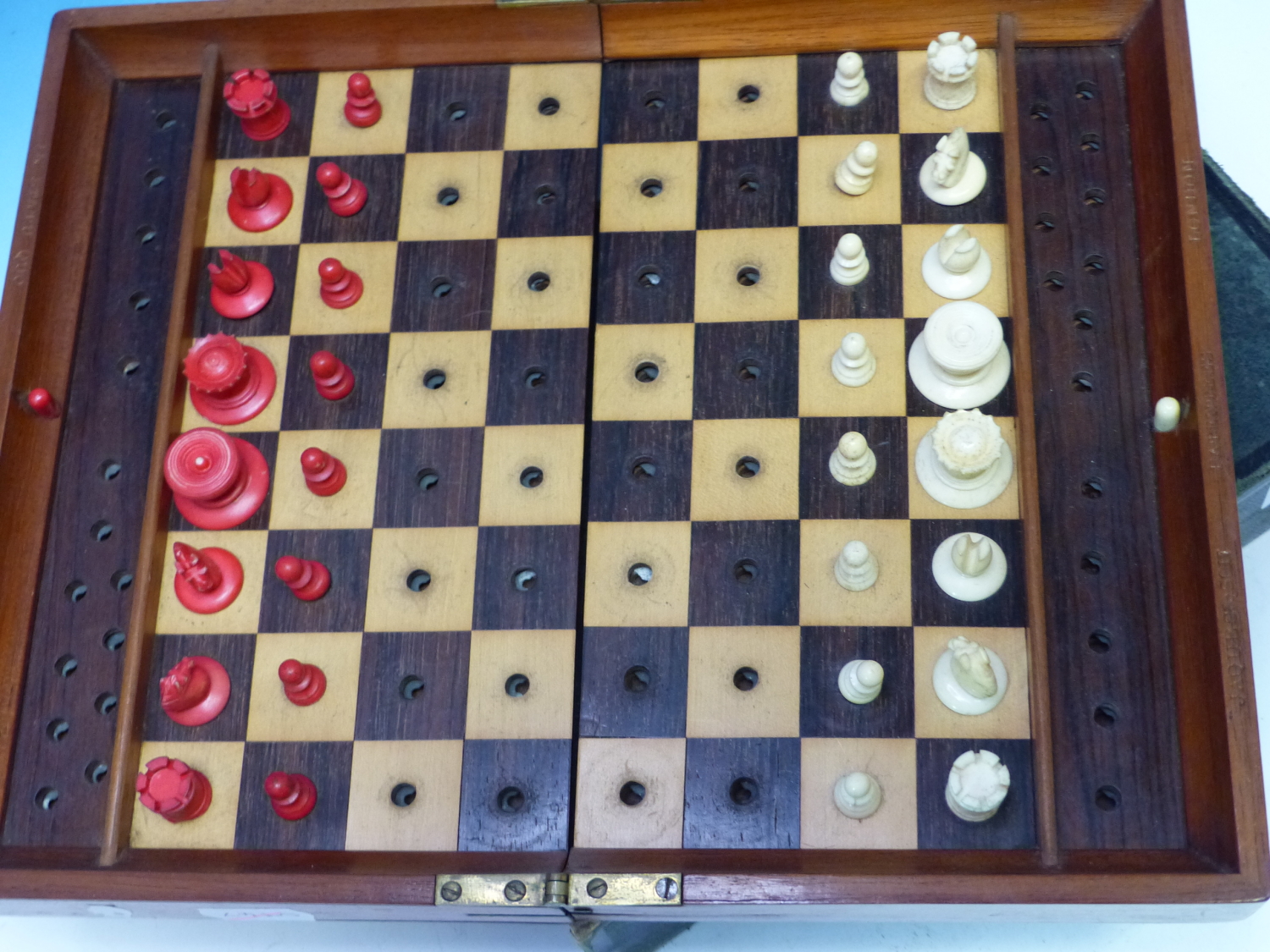 A JAQUES TRAVELLERS CHESS SET, THE MAHOGANY BOARD WITH LOCKS TO HOLD THE RED AND WHITE PIECES IN - Image 3 of 16