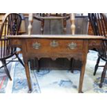 AN 18th C. OAK SIDE TABLE, THE CENTRAL DRAWER ABOVE A WAVY APRON RUNNING UP BELOW FLANKING DRAWERS