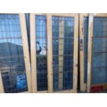 FIVE VINTAGE GLAZED DOORS MULTI PANED WITH BRONZE GLAZING BARS. W 77 X H 213 X D 5cms