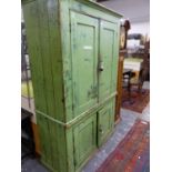 A 19th C. GREEN PAINTED PINE FLOOR STANDING CUPBOARD, THE TWO PAIRS OF DOORS ENCLOSING SHELVES. W