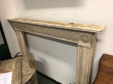 A WHITE PAINTED PINE FIRE SURROUND, ROUNDELS AT THE TOPS OF THE CHANNELLED UPRIGHTS. H 121 x W