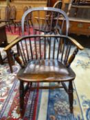 AN ANTIQUE LOW BACKED WINDSOR CHAIR WITH A ROUND ARCH SEVEN STICK BACK TOGETHER WITH A WHEEL BACKED