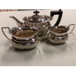 A SILVER HALLMARKED THREE PART TEA SERVICE, COMPRISING OF A TEAPOT, SUGAR BASIN AND CREAMER.