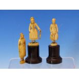 A PAIR OF DIEPPE IVORY FIGURES OF A FISHERMAN AND HIS WIFE STANDING ON EBONY PLINTHS. H 11cms.