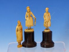 A PAIR OF DIEPPE IVORY FIGURES OF A FISHERMAN AND HIS WIFE STANDING ON EBONY PLINTHS. H 11cms.