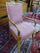 A 19th C. FRENCH FRUIT WOOD ELBOW CHAIR, THE SQUARE BACK AND SEAT UPHOLSTERED IN TERRACOTTA GROUND