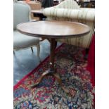 A GEORGIAN MAHOGANY TRIPOD TABLE, THE DISHED CIRCULAR TOP ON GUN BARREL COLUMN ABOVE CLUB FEET. Dia.