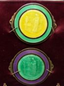 TWO BASSE TAILLE ENAMEL ROUNDELS OF ST BARTHOLOMEW MOUNTED ON PURPLE SILK WITHIN A FRAME. 12 x