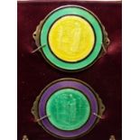 TWO BASSE TAILLE ENAMEL ROUNDELS OF ST BARTHOLOMEW MOUNTED ON PURPLE SILK WITHIN A FRAME. 12 x