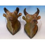 A PAIR OF INDIAN PAINTED TERRACOTTA WALL HANGING HEADS OF COWS. H 23cms.