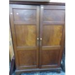 AN ANTIQUE MAHOGANY HALL CABINET WITH PANELLED DOORS.